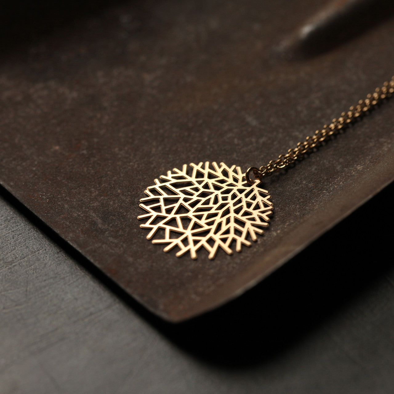 Moorigin laser cut and gold plated steel woods necklace