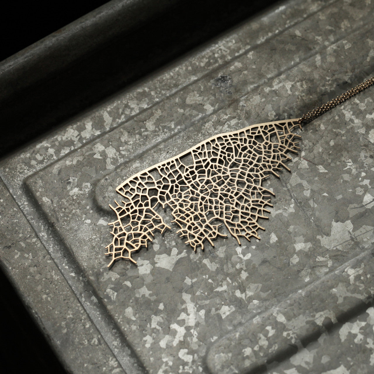 Moorigin gold plated stainless steel pendant with skeleton leaf motif